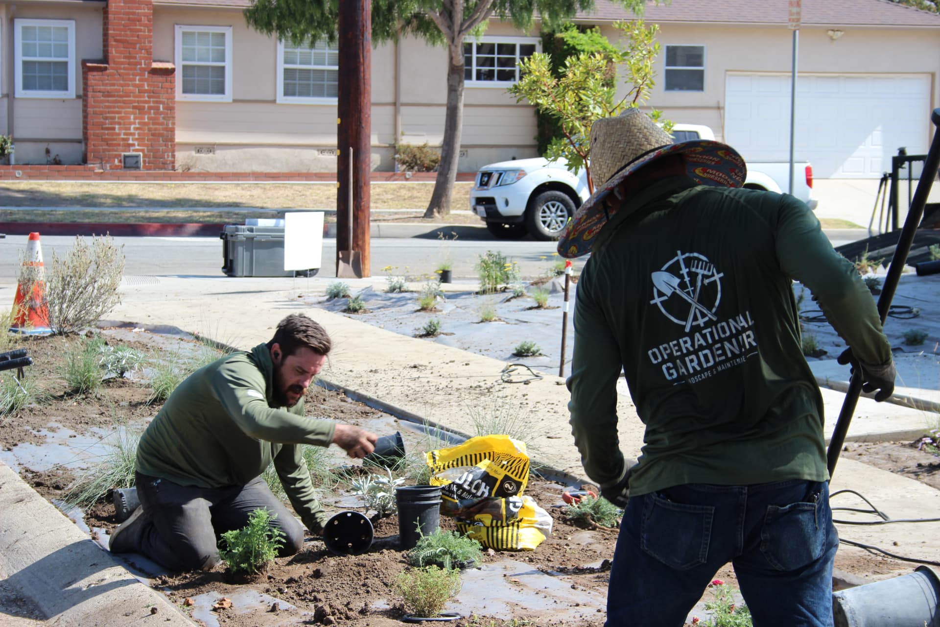 Operational Gardener crew planting drought-tolerant landscaping on a Southern California front yard