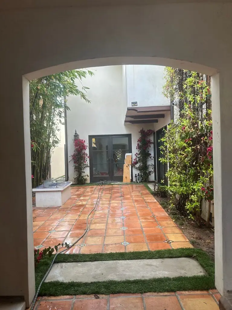 Spanish courtyard with Saltillo tile patio, bougainvillea and bamboo maintained to standard — Operational Gardener veteran-owned landscaping in Palos Verdes, CA